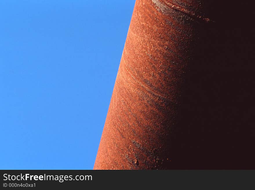 Border created by rusty pipe and sky