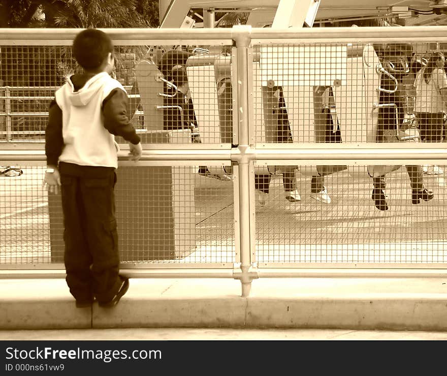 Small boy waiting for a ride at an amusement park