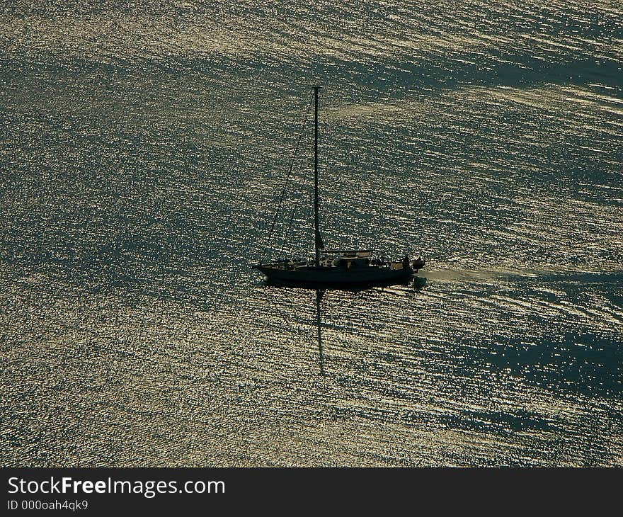 Silhouette of sailing boat in the open sea