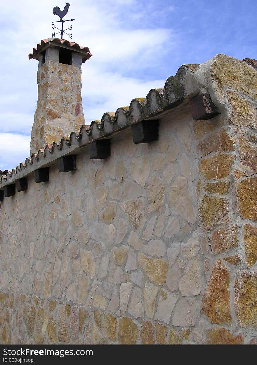 Stone chimney with weathervane. Stone chimney with weathervane