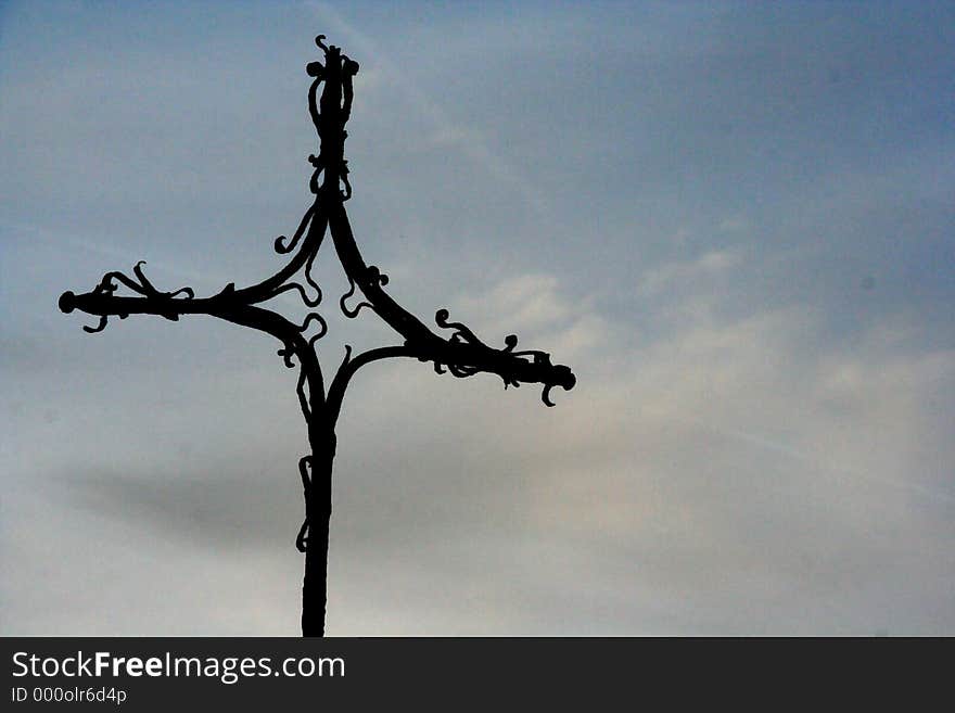 Silhouette of cross against a sunset sky