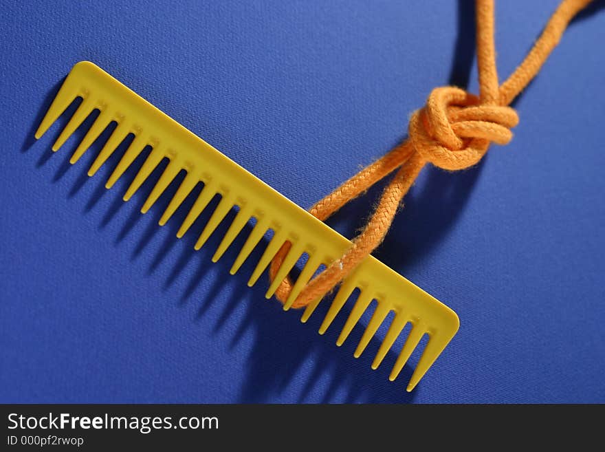 Comb and knot on blue background. Comb and knot on blue background