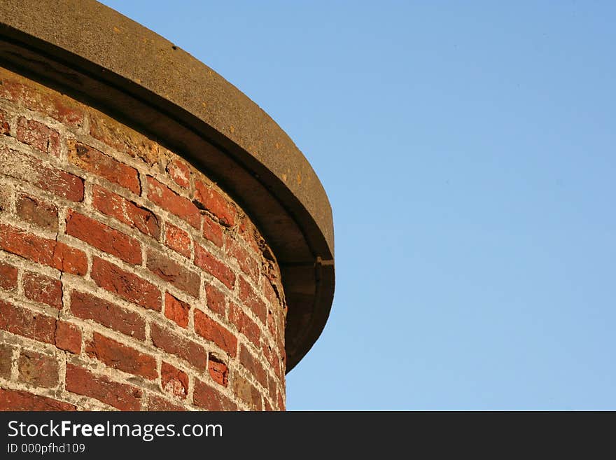 Edge of a rounded wall agisnt blue sky