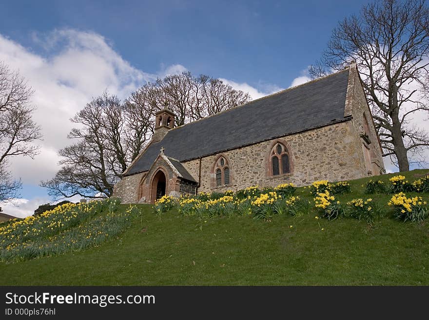 An old Scottish Kirk (church) in springtime with dafodils. An old Scottish Kirk (church) in springtime with dafodils.