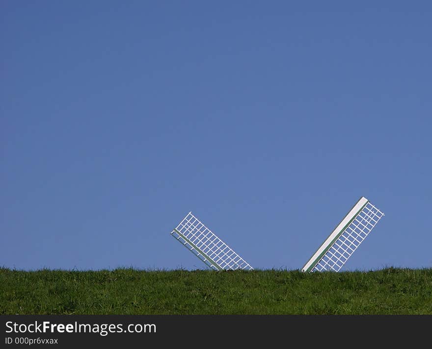 windmill behind a grass hill. windmill behind a grass hill