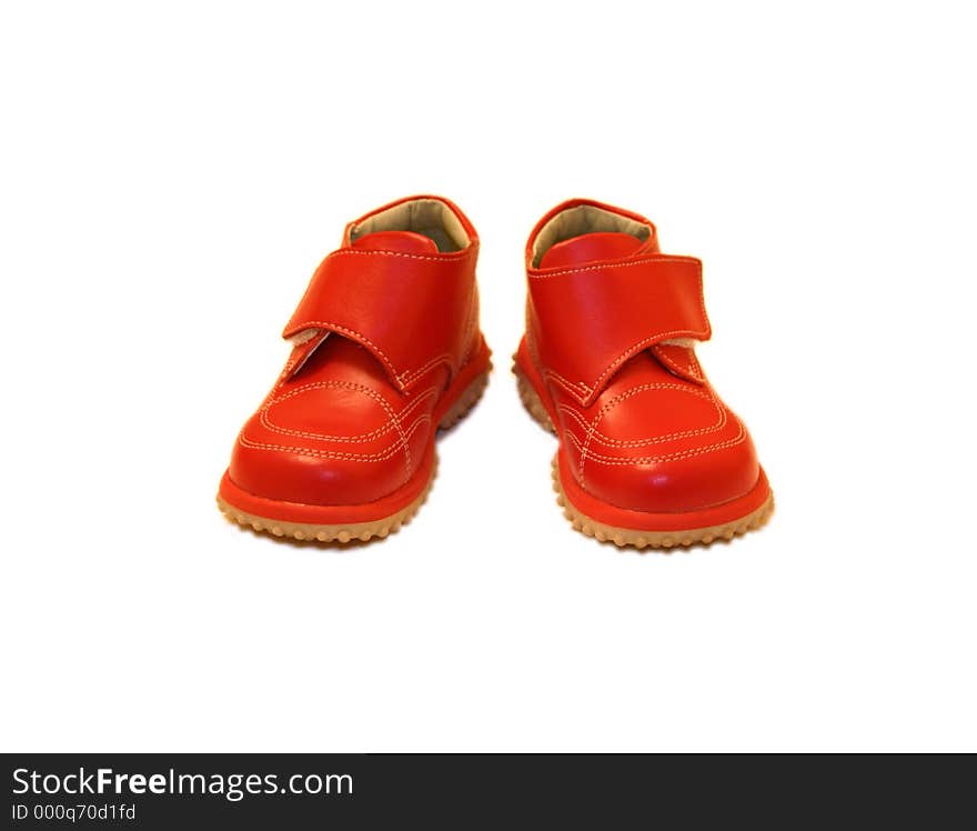 A pair of shiny red baby shoes - front