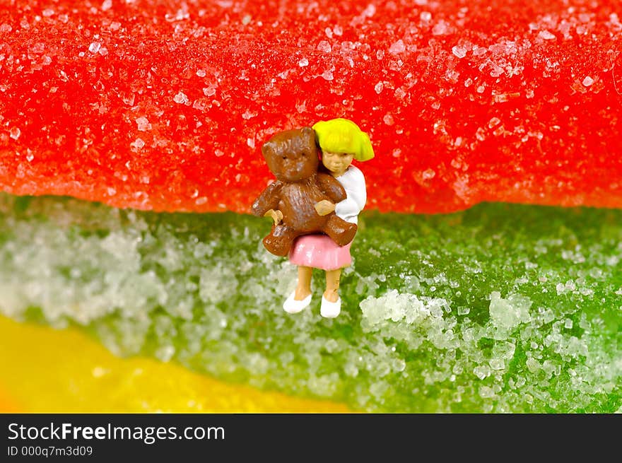 Miniature Child Sitting on Jelly Candy