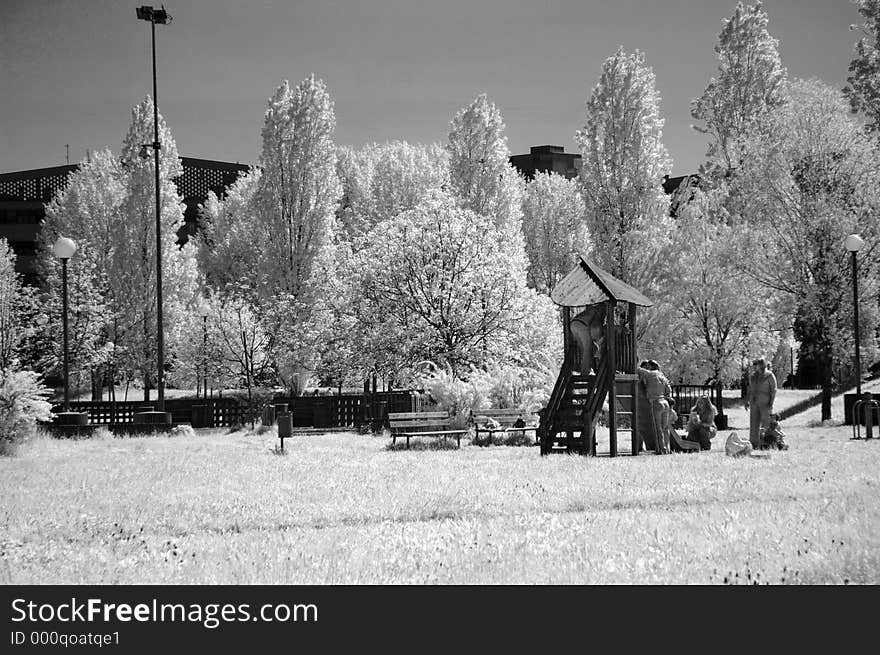 Children and moms in the park - photo took with infrared filter. Children and moms in the park - photo took with infrared filter