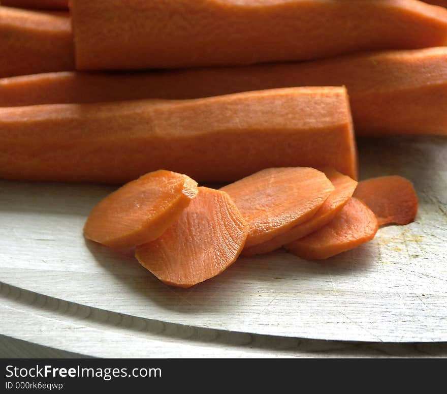 Carrotts on a cut up cutting board,shallow dof