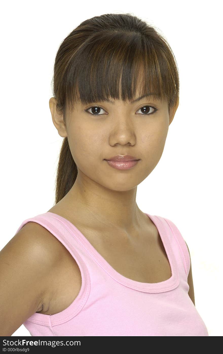 A cute young asian girl in a pink top and a hint of a smile. A cute young asian girl in a pink top and a hint of a smile