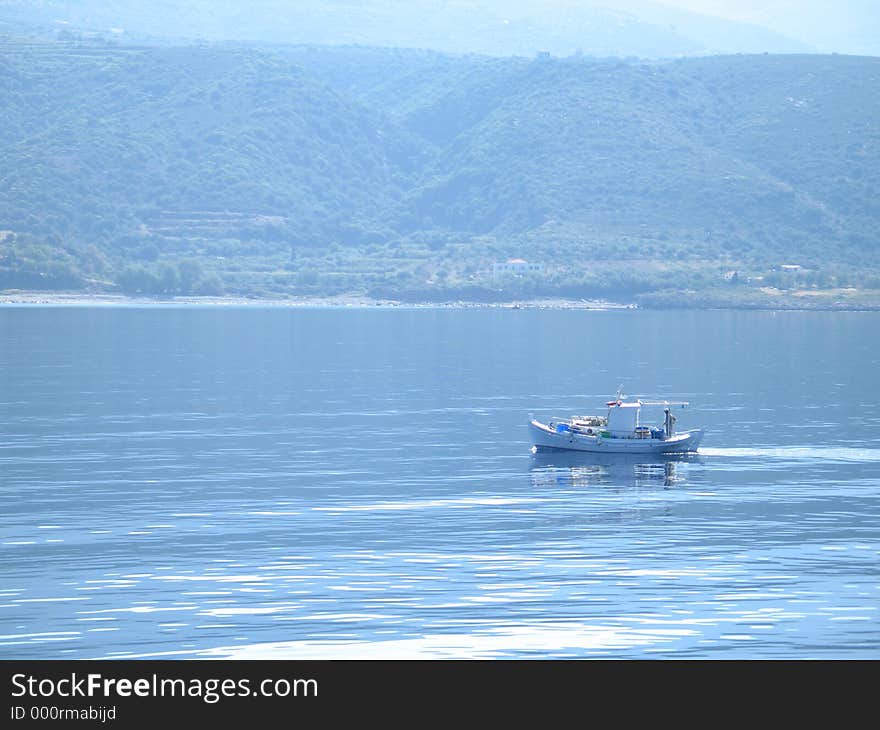 A fisherman coming back from early-morning fishing in the seas of Neapoli Lakonias, Greece. A fisherman coming back from early-morning fishing in the seas of Neapoli Lakonias, Greece