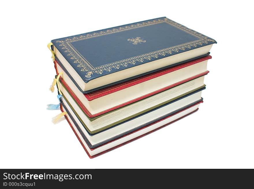 Stack of colourful old books - white background