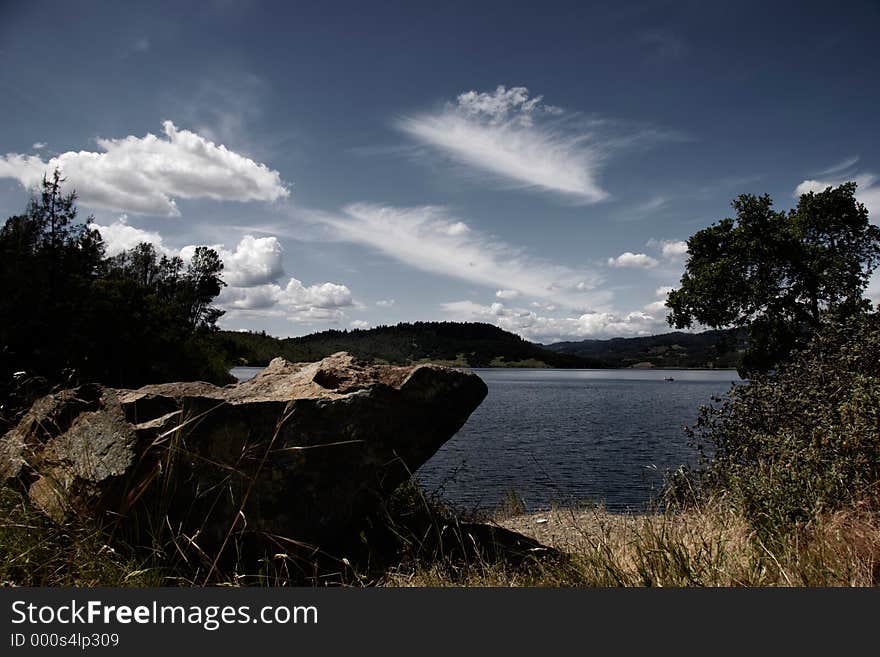 Boulder by still lake