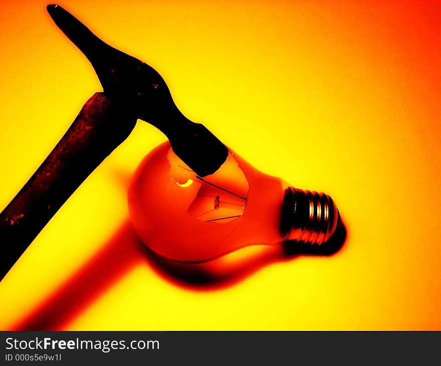 This is a conceptual image of a hammer breaking a lightbulb. This is a conceptual image of a hammer breaking a lightbulb.