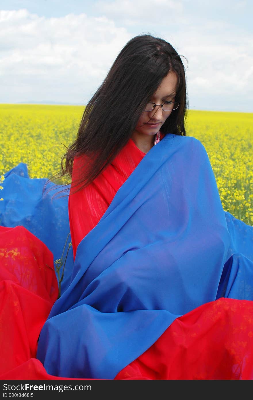 Woman meditating in the middle of nature. red and blue scarfs are helping. Woman meditating in the middle of nature. red and blue scarfs are helping.