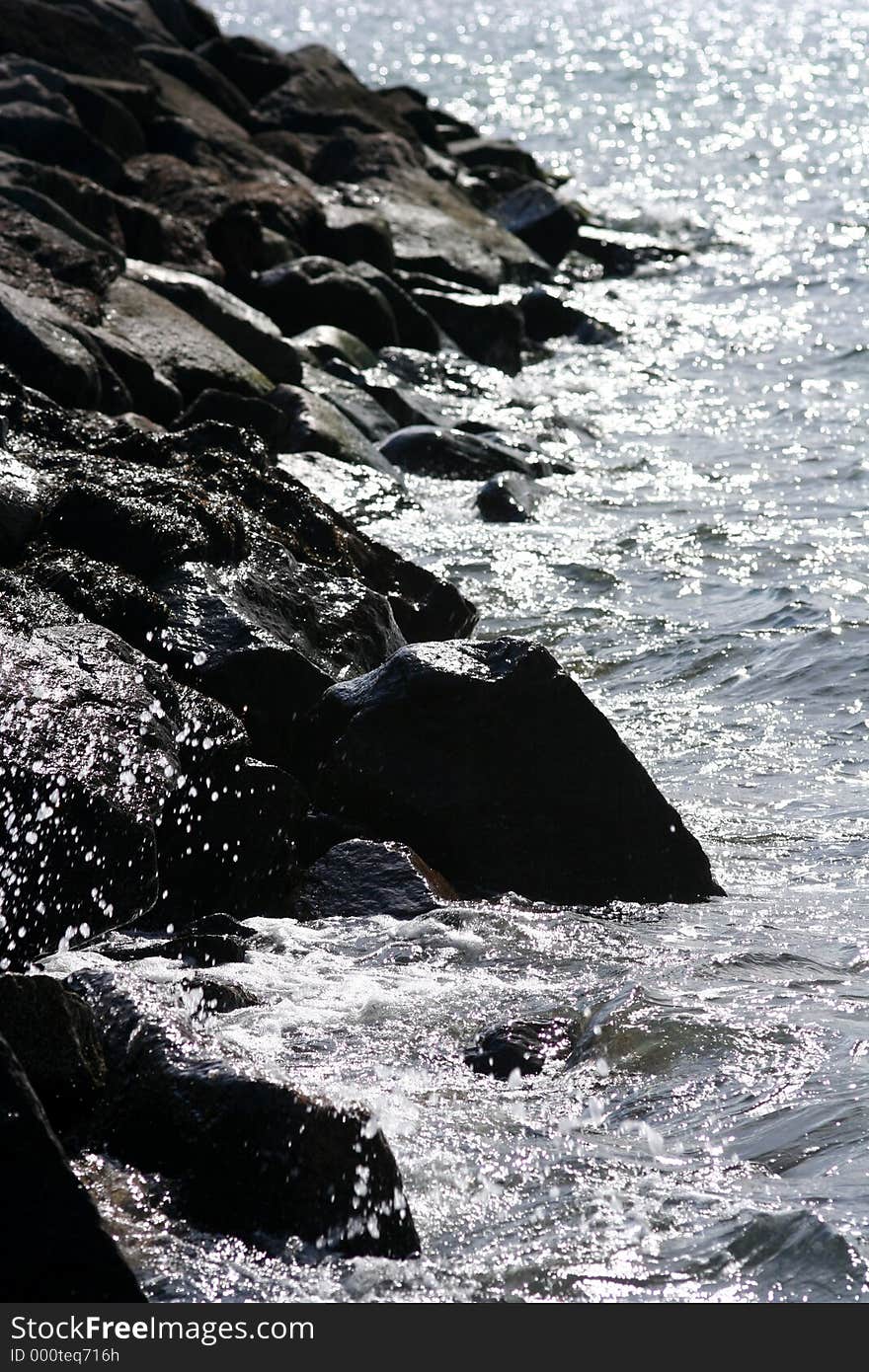 Stone coast with water.