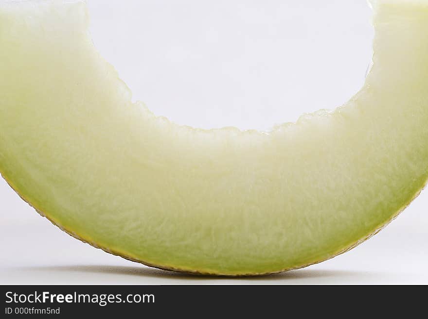 Slice of a cantoloupe on a white background. Slice of a cantoloupe on a white background