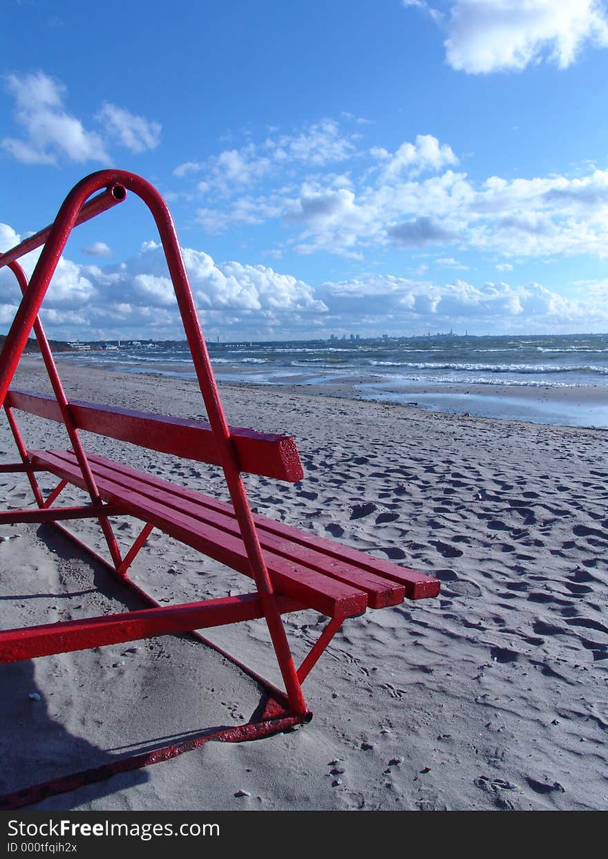 Red Bench On The Beach