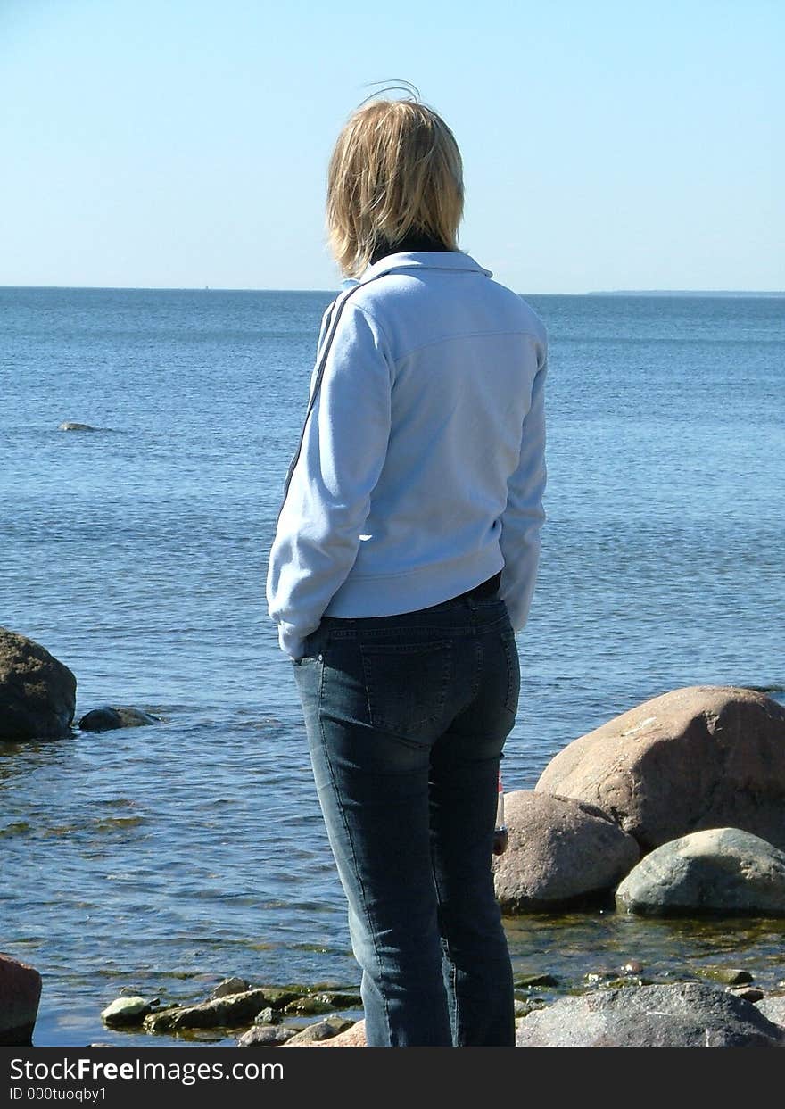 Woman standing on a rocky beach