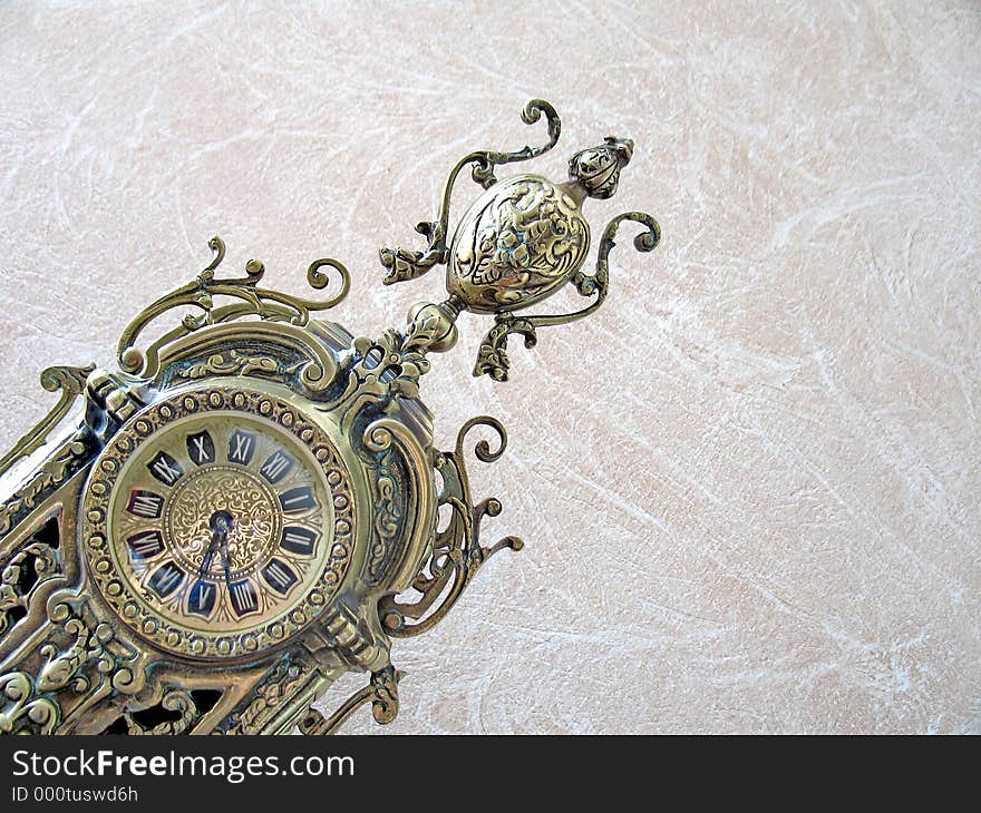 An antique bronze clock - leaning shot. An antique bronze clock - leaning shot