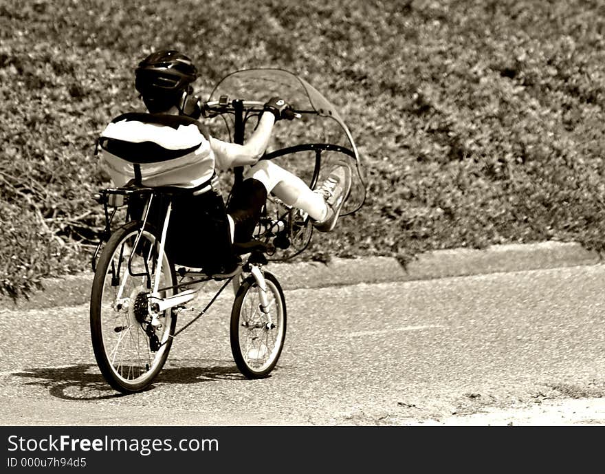 Man Riding A Unique Bike With A Windshield