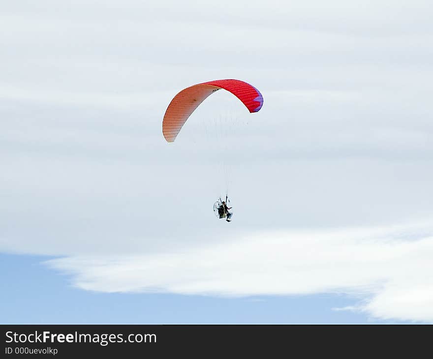 Red Hang glider in the clouds