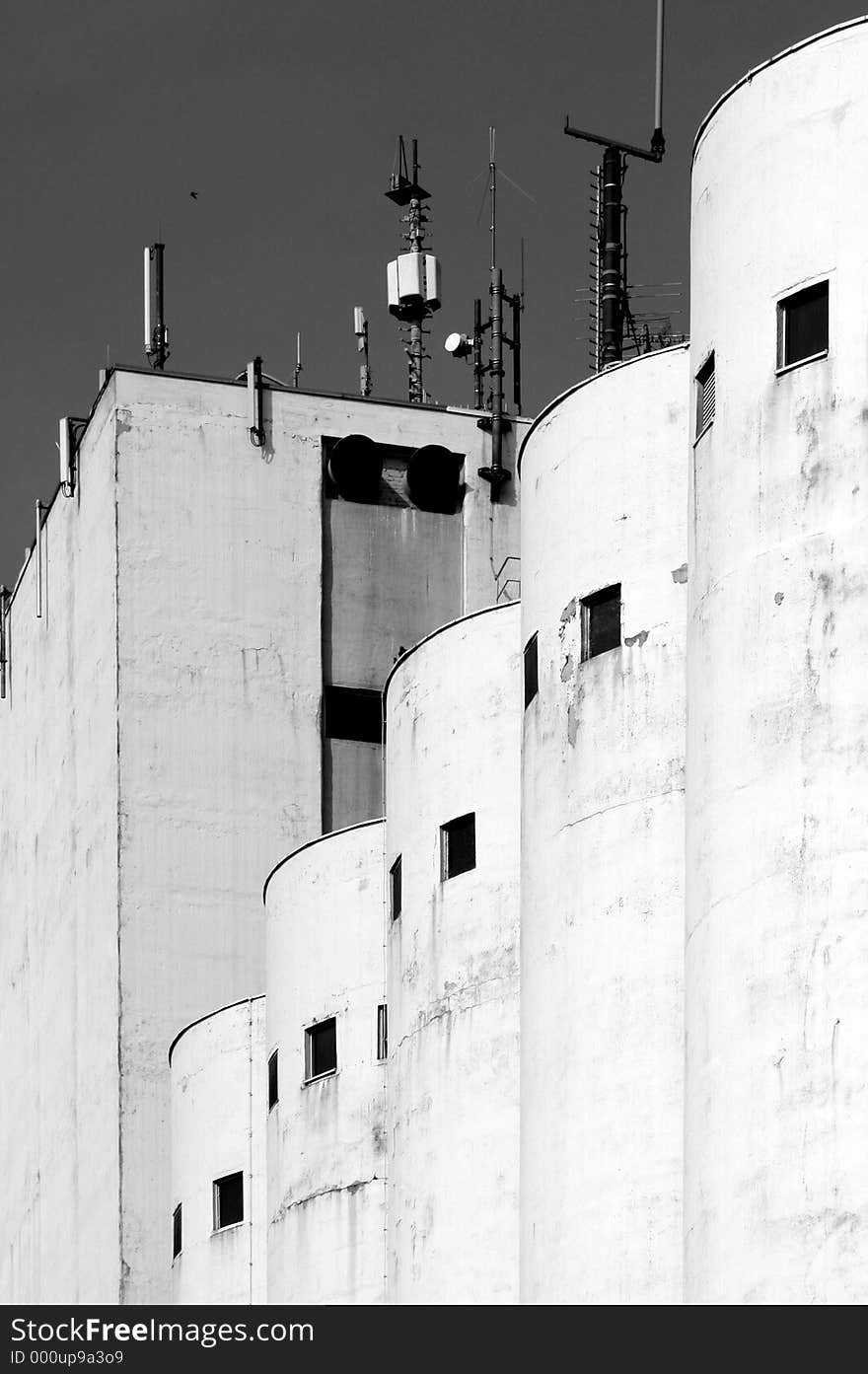 Industrial building from ex-comunist side of Germany. Many cities from Eastern part have such buildings, some of them still holding activities but many others going to be ruins. Image taken in a sunny day, desaturated in post-processing for higher impact. Industrial building from ex-comunist side of Germany. Many cities from Eastern part have such buildings, some of them still holding activities but many others going to be ruins. Image taken in a sunny day, desaturated in post-processing for higher impact.