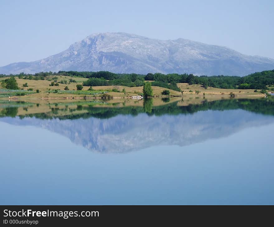 Mountain reflecting in perfectly calm lake. Mountain reflecting in perfectly calm lake