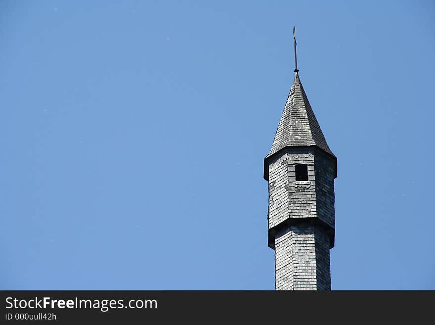 Detail of castle tower against blue sky background