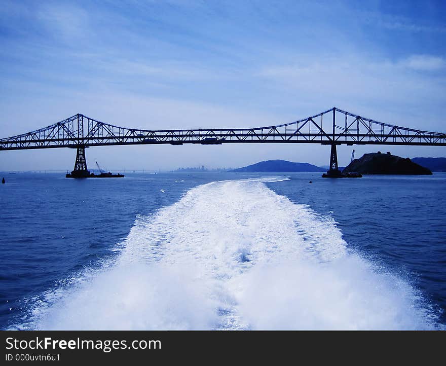 Long shot of Richmond San Rafael bridge North of San Francisco, in between San Rafael and Richmond.Taken from the deck of a ferry boat, water trail apparent. Long shot of Richmond San Rafael bridge North of San Francisco, in between San Rafael and Richmond.Taken from the deck of a ferry boat, water trail apparent.