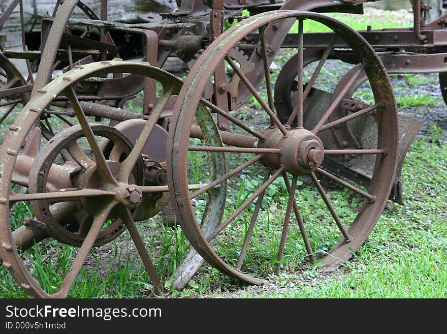 Close up of old plow wheels metal rusty. Close up of old plow wheels metal rusty