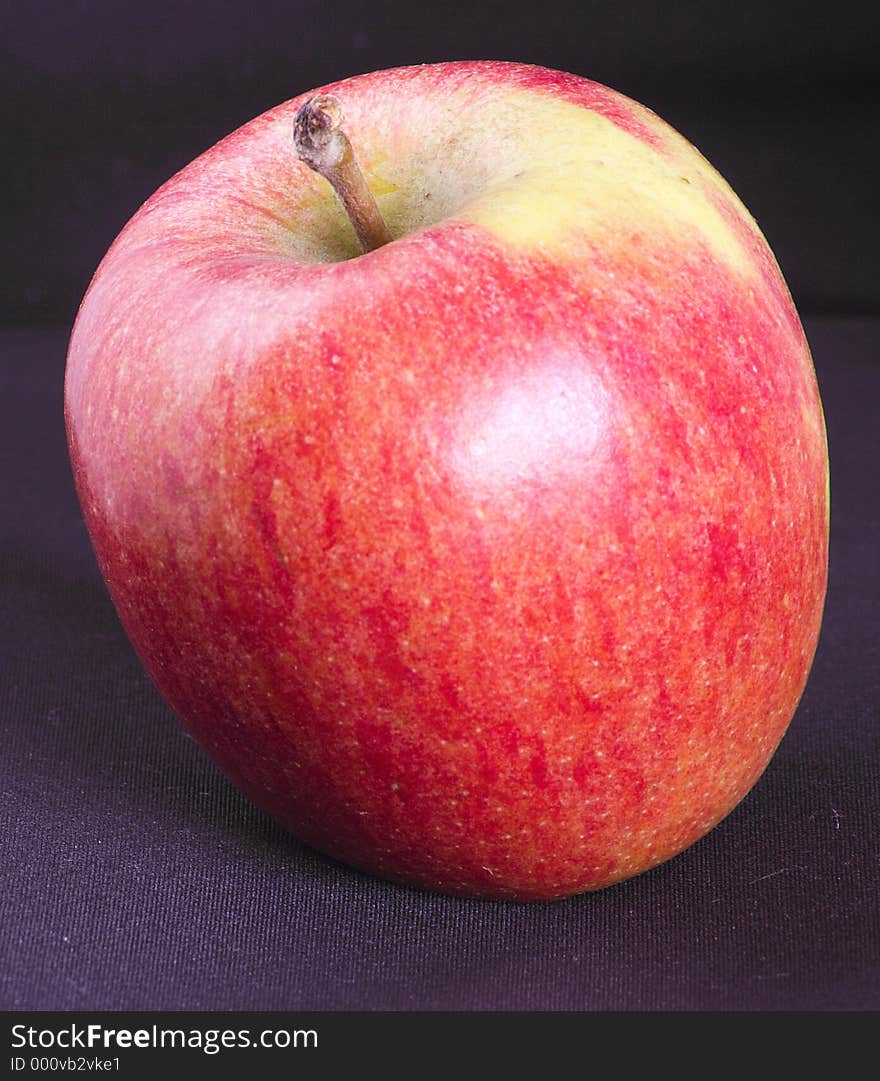 Rosy apple against a dark background