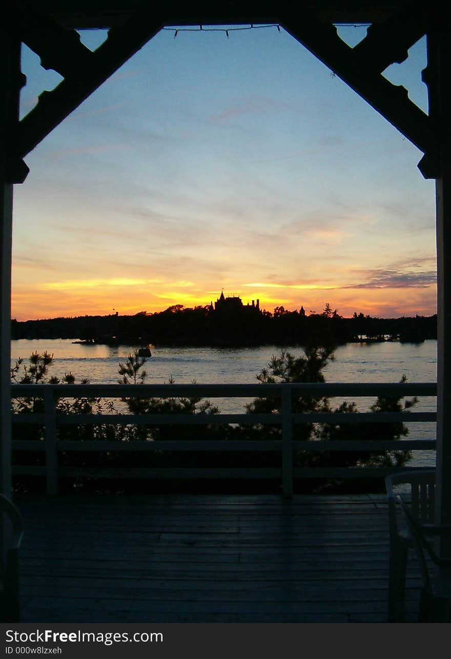 Boldt Castle silhouetted in the sunset framed by the arch of a Gazebo on Lake Ontario. Boldt Castle silhouetted in the sunset framed by the arch of a Gazebo on Lake Ontario.