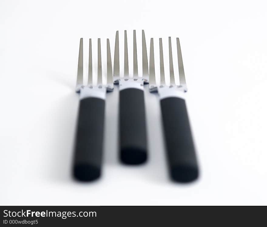 Three forks against a white background