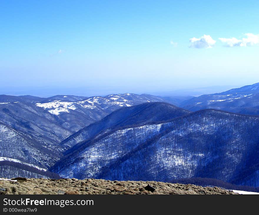 Here are some mountains in Romanian full of snow and trees. Here are some mountains in Romanian full of snow and trees.