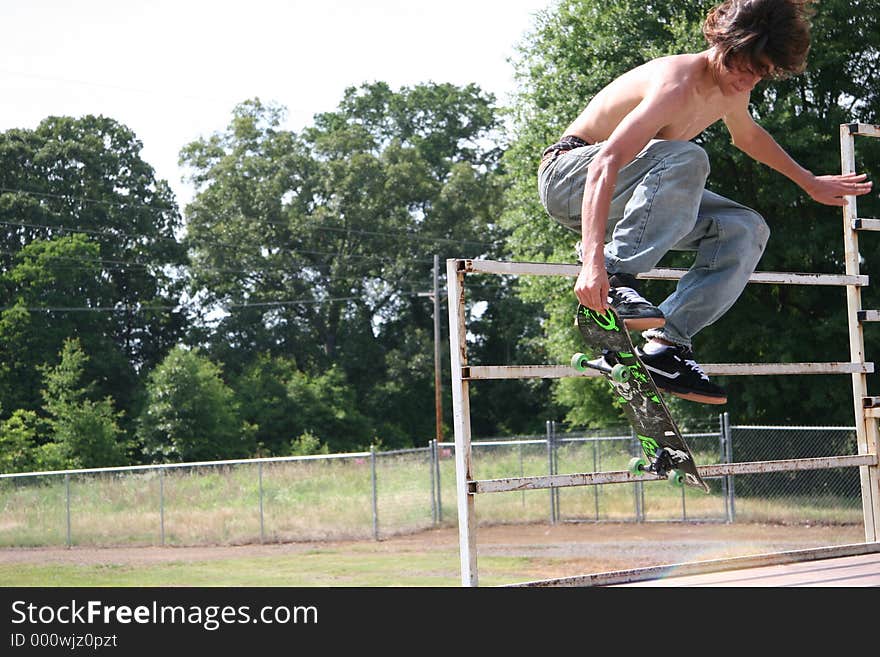 Teen skateboarder flying through air grabbing board. Shot with Canon 20D. Teen skateboarder flying through air grabbing board. Shot with Canon 20D.