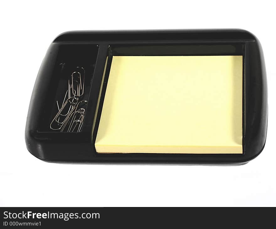 Desktop accessory for hold pad and paper clips; blank yellow pad. Desktop accessory for hold pad and paper clips; blank yellow pad