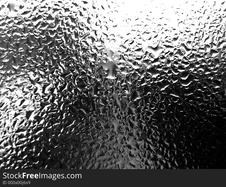 A glass full of water droplets