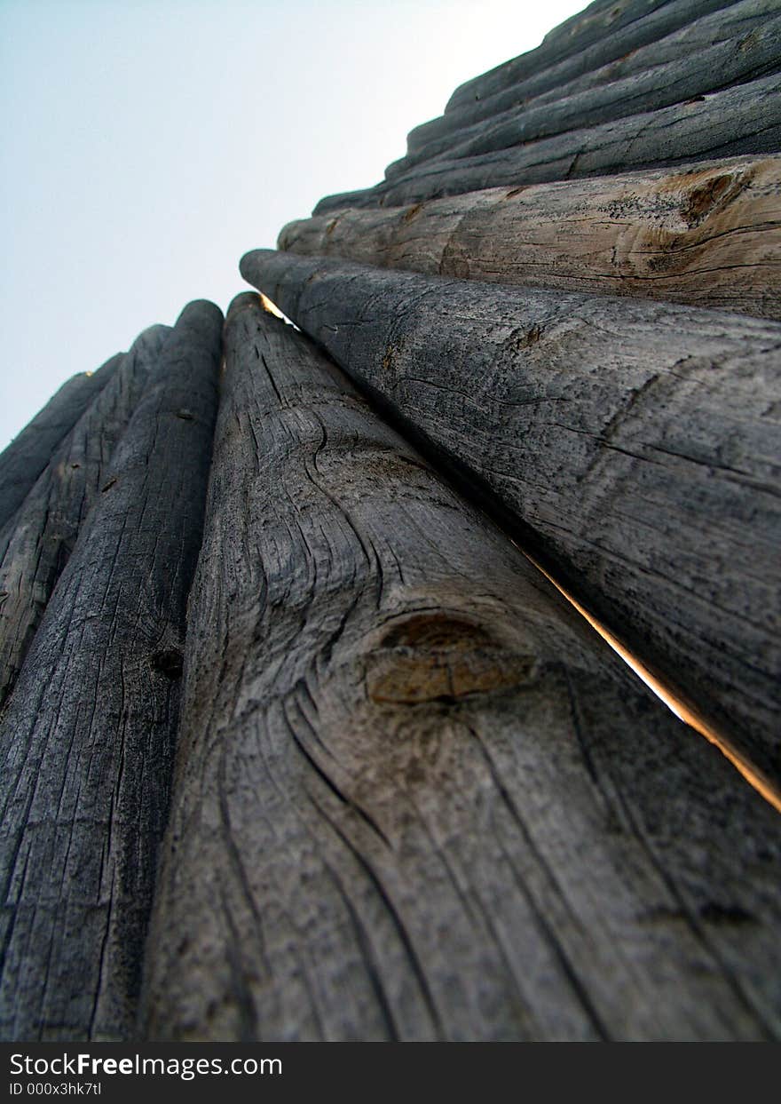 Part of a wooden log picket wall. Part of a wooden log picket wall