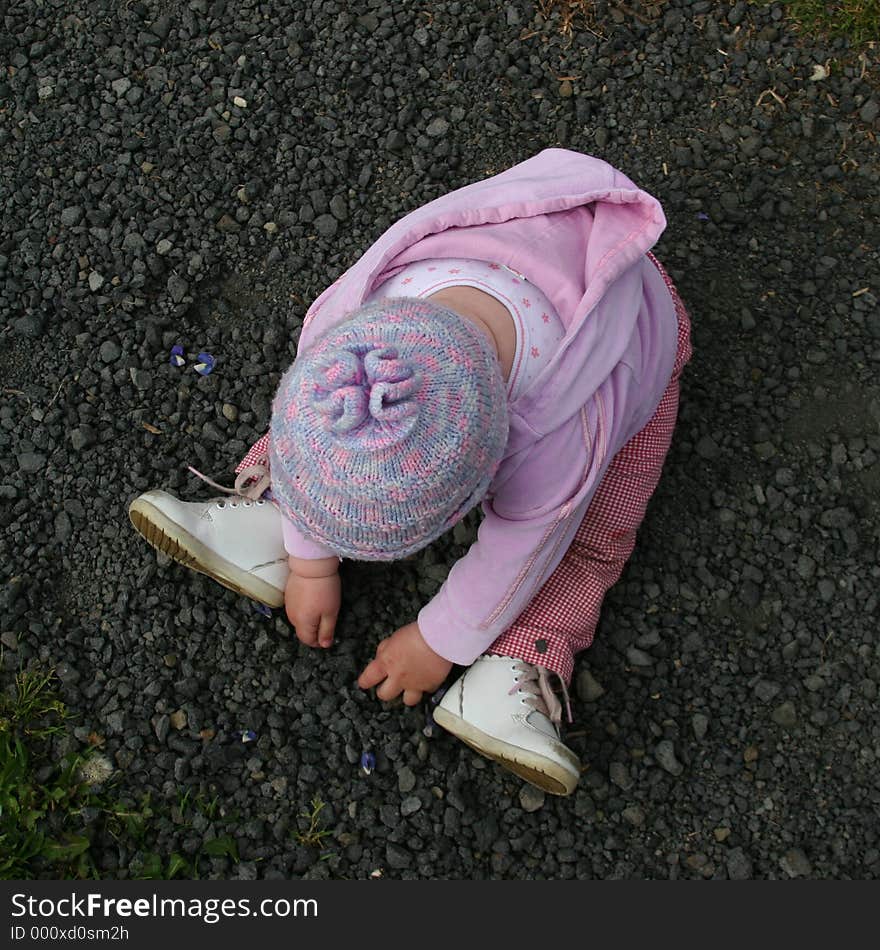 Girl playing with pebbles