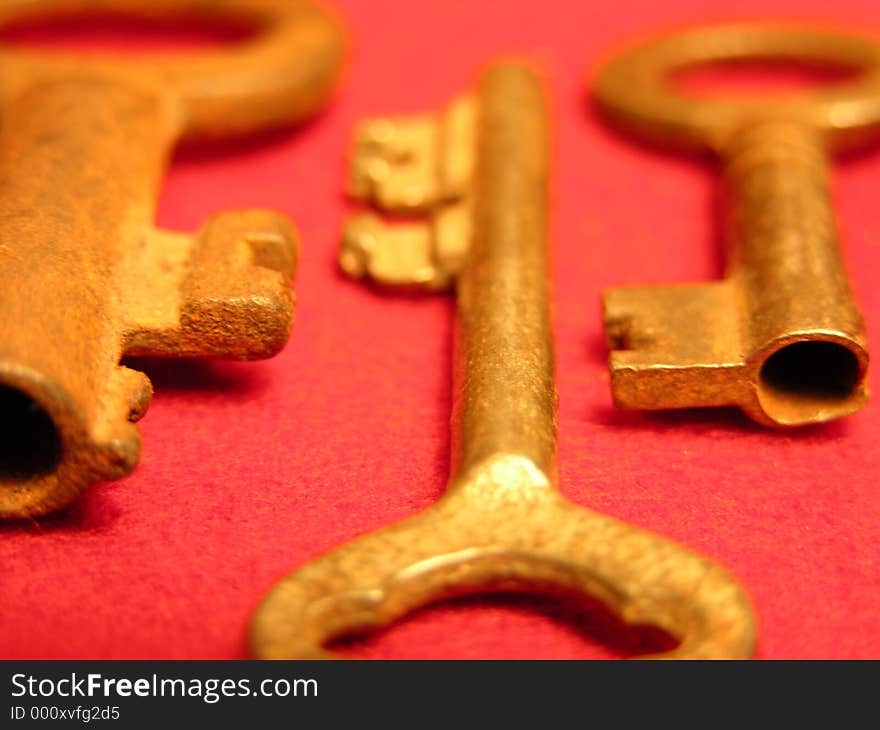 Antique Gold Keys on red background