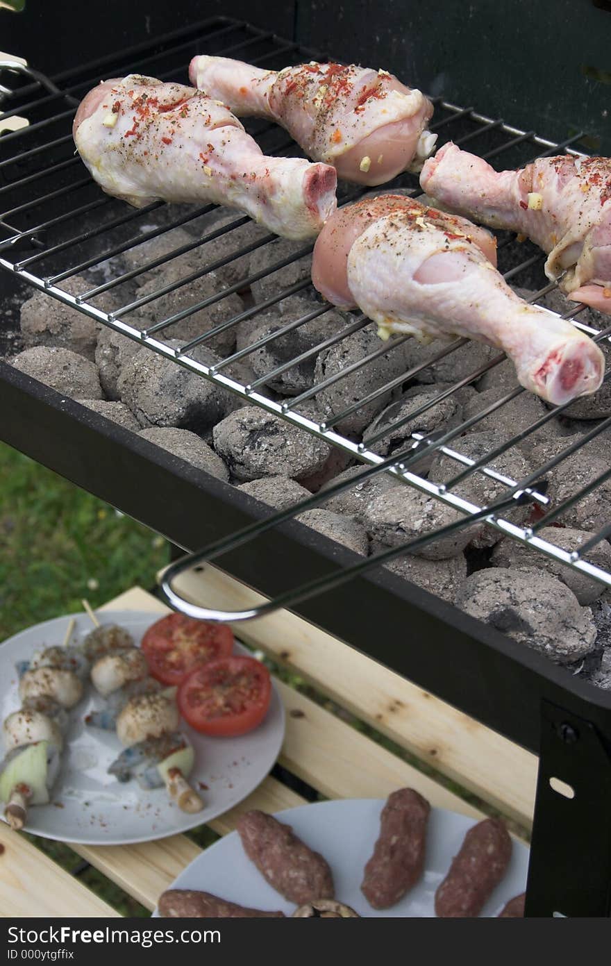 Close up of a barbeque cooking chicken drumsticks. Close up of a barbeque cooking chicken drumsticks