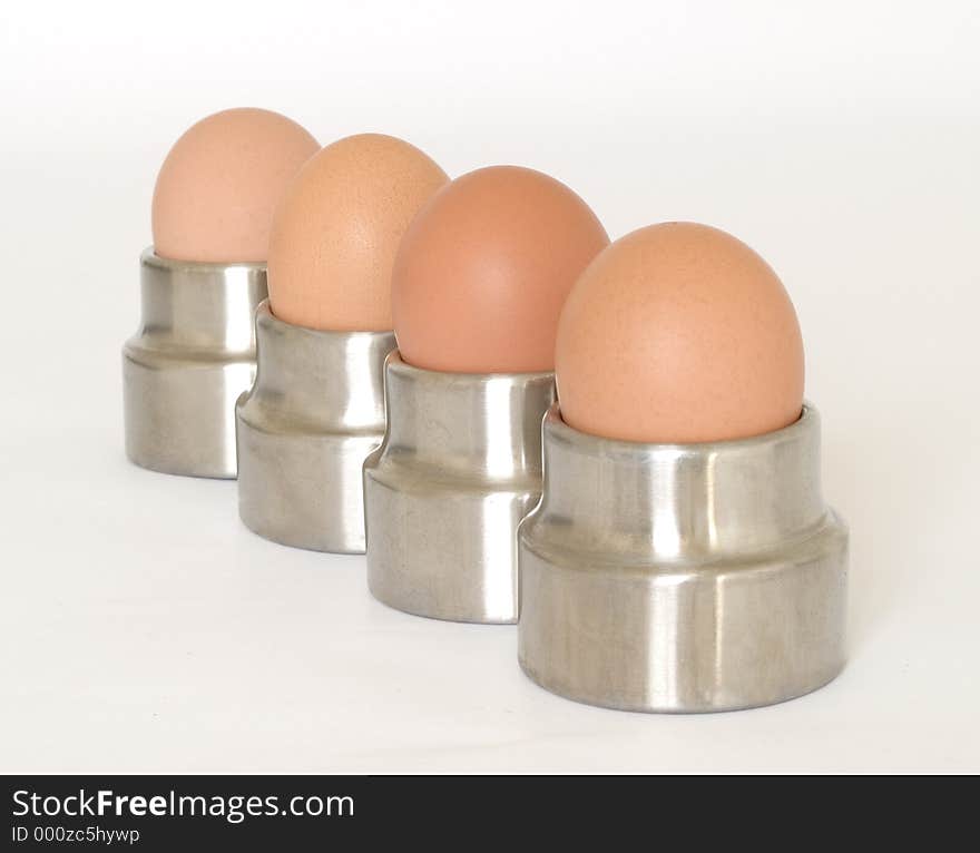 Four eggs in egg cups. Four eggs in egg cups