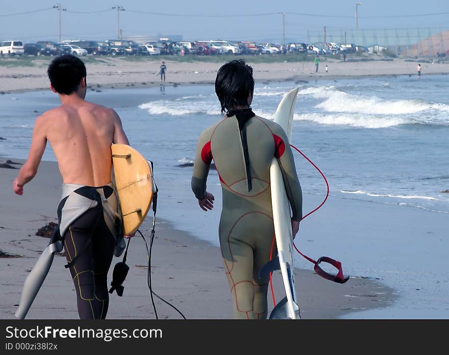 Two surfers on the ocean beach
