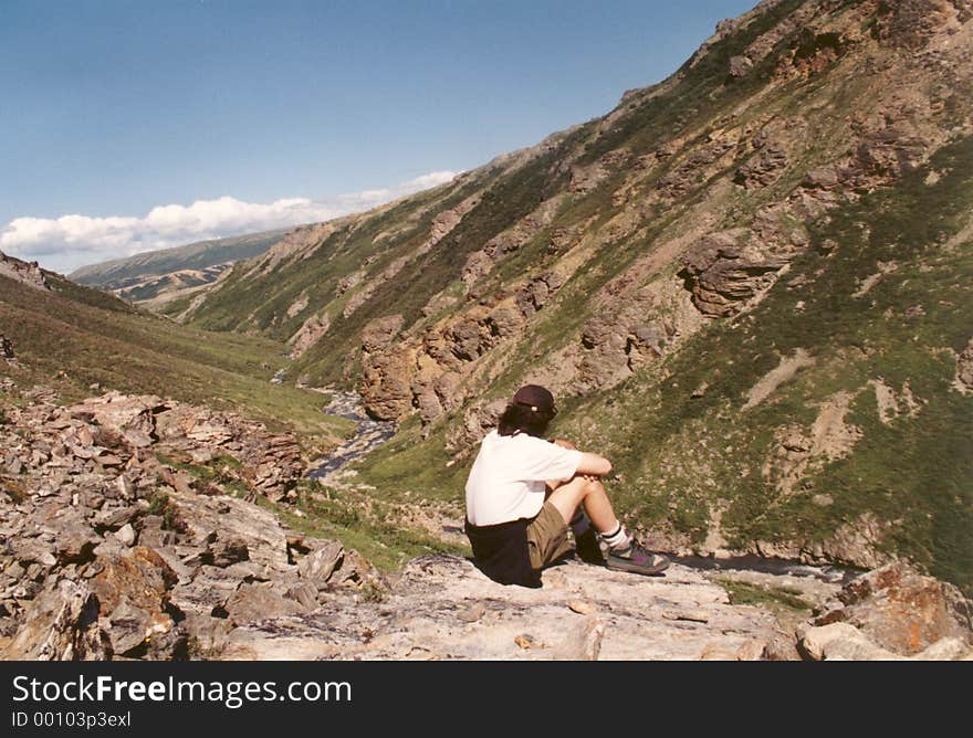 A young man overlooking the mountains in Alaska. A young man overlooking the mountains in Alaska