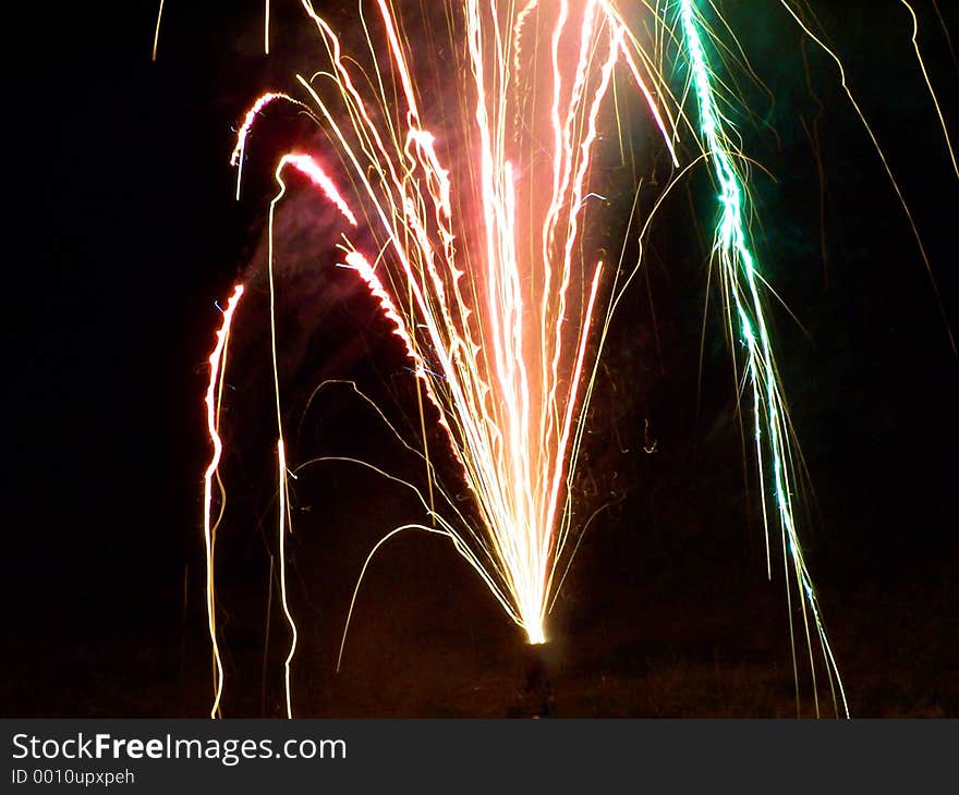 Multi-color fireworks shot in a backyard.