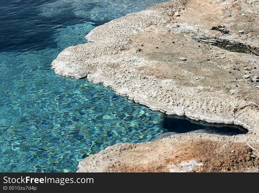 Beautifully clear and turquoise water at a mineral pool in yellowstone national park. Beautifully clear and turquoise water at a mineral pool in yellowstone national park