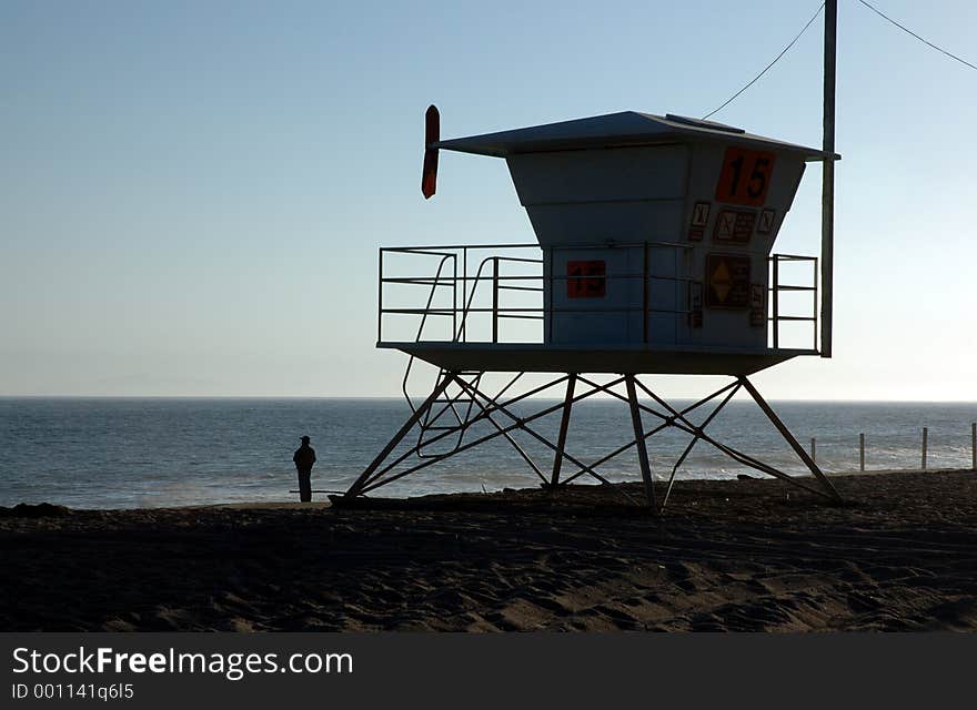 Silhouette of a lifeguard house and person. Silhouette of a lifeguard house and person