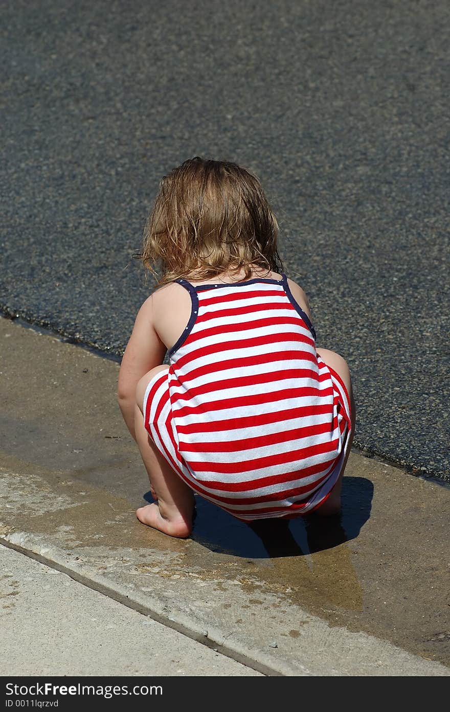 Toddler playing in a puddle. Toddler playing in a puddle