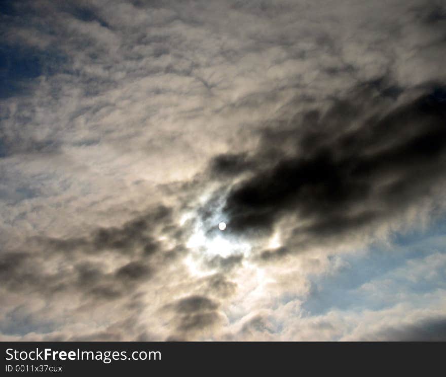 The sun hiding behind the clouds. The sun hiding behind the clouds